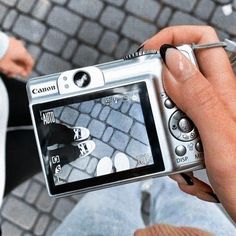 a person holding up a camera to take a picture