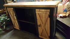 a wooden cabinet sitting in the middle of a room with an american flag on it