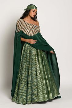 Editor's Note Featuring A Multicolor Thread Detailed Chanderi Skirt. It Is Paired With precisely Multicolor Thread And Zari Detailed Shoulder Drape Cape. Color: Green Fabric: Chanderi And Crepe Care: Dry Clean Only About the Designer Rishi & Vibhuti label combines traditional elements with modern aesthetic uniquely to create chic occasion wear for women with a fine choice. The global appeal in their designs has made Rishi & Vibhuti one of the sought-after labels in a short span of time. Cape Skirt, Pola Rok, Jacket Lehenga, Mehndi Outfit, Reception Bride, Fusion Wear, Cotton Blouse Design, Party Reception, Lehenga Blouse Designs