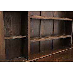 an old wooden bookcase with two shelves on one side and another shelf in the other