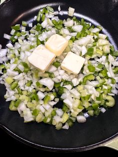 diced onions and cubed cheese in a skillet