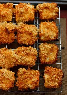 some fried food is on a cooling rack and ready to be cooked in the oven