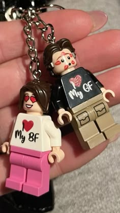 two legos are holding on to each other in the palm of someone's hand