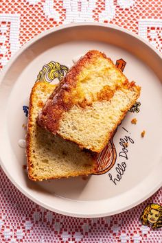 two slices of cake on a plate with the words happy birthday written on it and an orange background