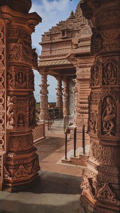 an intricately carved stone structure with pillars