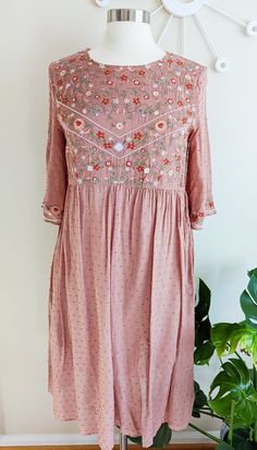 Pretty swiss dot embroidered dress. Easy and breezy! Trendy boho style. Pair with booties or simple sneaks! Fit: True to size and flowy, no stretch; lining has some stretch Keyhole button on back Fully lined (sleeves are not lined) Half sleeve, slightly flared Embroidered on bodice and sleeve edges Straight hem Fabric: 100% rayon, lining 95% polyester, 5% spandex Bust: Small 38in, Medium 40in, Large, 42in Length: Small 40.5in, Medium 40.5in, Large 41in Washing Instructions: Wash cold, line dry Embroidered Bohemian Dress, Bohemian Embroidered Dress, Classroom Style, Trendy Boho, Spring Tops, Swiss Dot, Dress Jewelry, Peasant Tops, Bohemian Dress