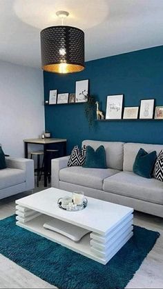 a living room with blue walls and white furniture