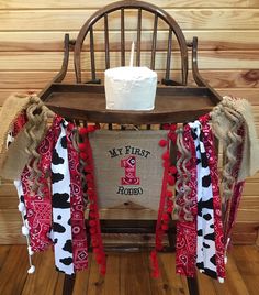 a chair with a birthday cake on top of it and some ribbons around the seat