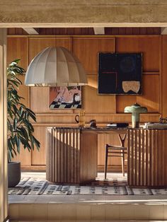 a kitchen with wooden cabinets and an island in front of a painting on the wall