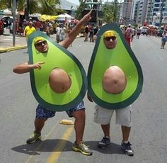 two people are standing in an avocado costume