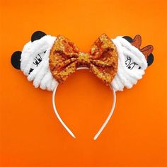 a close up of a mouse ears on an orange background