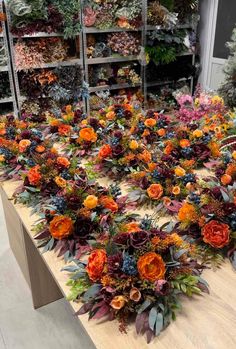 an arrangement of flowers on a table in a flower shop