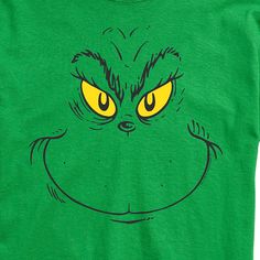 a green t - shirt with the grin face drawn on it's chest and yellow eyes