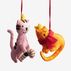 two stuffed animals hanging from strings in the shape of cat and kitten's head