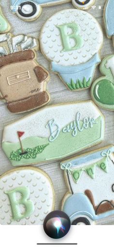 decorated cookies for a baby's first birthday with golf and cars in the background