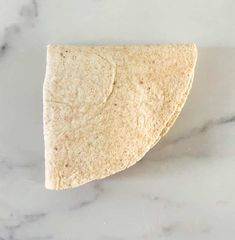 a piece of tortilla sitting on top of a white counter