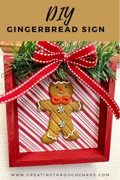 a homemade gingerbread sign hanging from a wooden frame with red and white striped ribbon