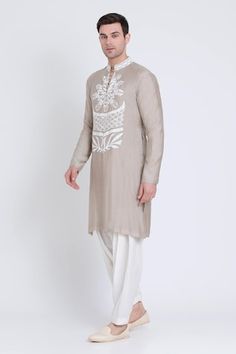 Ecru kurta featuring embroidered patch in geometric pattern and silk resham embroidery all over. Paired with a contrasting plain dhoti pant. - Aza Fashions Transitional Cotton Kurta With Geometric Embroidery, Traditional Straight Kurta With Geometric Embroidery, Traditional Kurta With Geometric Embroidery For Eid, Traditional Sets With Geometric Embroidery For Transitional Season, Geometric Embroidered Kurta For Eid Wedding, Geometric Embroidery Kurta For Wedding On Eid, Geometric Embroidery Kurta For Wedding And Eid, Geometric Embroidery Kurta For Eid Wedding, Traditional Wear With Geometric Embroidery For Eid Wedding