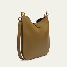 TOM FORD "Tara" crossbody hobo bag in leather, faux leather (polyurethane), and brass  Adjustable, detachable flat crossbody strap Open top with T-strap magnetic closure; zip closure  Lining: Polyurethane Approx. 15"H x 15.7"W x 1.6"D Item Weight (Lbs.): 1.9 Made in Italy Modern Crossbody Hobo Bag With Metal Hardware, Workwear Hobo Bag With Metal Hardware Crossbody, Versatile Leather Hobo Bag With Metal Hardware, Versatile Leather Hobo Bag With Gold-tone Hardware, Versatile Hobo Bag With Gold-tone Hardware For Work, Leather Hobo Bag With Metal Hardware For Work, Office Crossbody Hobo Bag With Metal Hardware, Modern Crossbody Hobo Bag With Gold-tone Hardware, Office Hobo Bag With Gold-tone Hardware