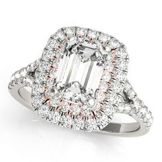 an oval cut diamond ring with halos around it