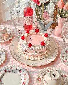 a table topped with plates and cups filled with cake