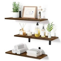 two shelves with towels, soaps and other items on them