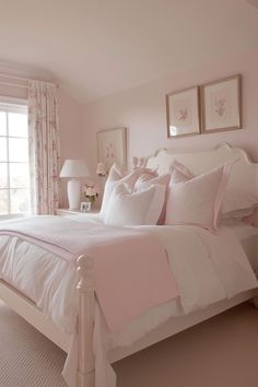 a bedroom with pink walls and white bedding