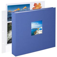 a blue binder with three pictures on it and an orange leaf in the middle