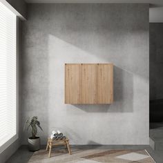 an empty room with a wooden cabinet on the wall