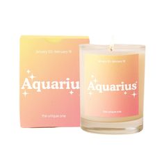 a candle that is next to a box on a white background with the words taurus