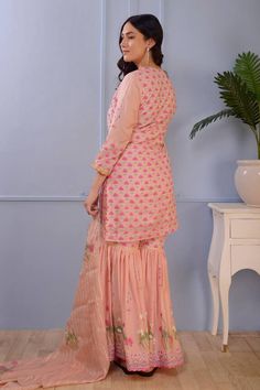 Pink cotton silk kurta with hand block print and lace finish. Comes with foil printed gharara and scalloped viscose organza dupatta with lace finishing.
Component: 3
Pattern: Print
Type Of Work: Foil Print, Hand Block Print
Neckline: Scoop
Sleeve Type: Three quarter
Fabric: Kurta and Gharara: Cotton Silk; Dupatta: Viscose   Stripe Organza
Color: Pink
Other Details: 
Hand block print
Foil print
Scallop dupatta
Occasion: Sangeet - Aza Fashions Scallop Dupatta, Pink Foil, Types Of Work, Silk Kurta, Luxury Sale, Organza Dupatta, Silk Dupatta, Foil Print, Pink Cotton