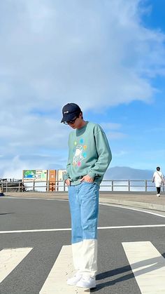 a man standing in the middle of an empty street with his hands on his hips