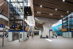 people are walking around in an airport terminal