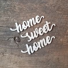 the words home sweet home are placed on top of a piece of wooden planks