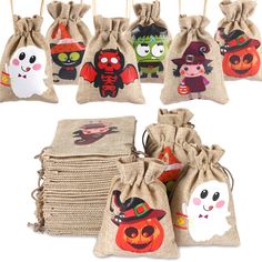 several bags with cartoon characters on them are hanging from clothes pins and decorated with pumpkins