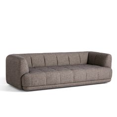 a gray couch sitting on top of a white floor