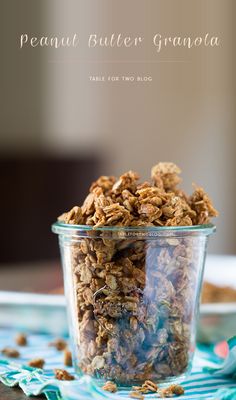 a glass bowl filled with granola sitting on top of a table