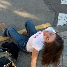 a woman laying on the ground with her head down