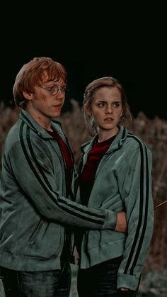 two people standing next to each other in front of a black background with the words harry potter