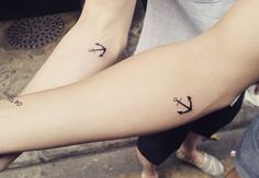 two people with matching tattoos on their arms