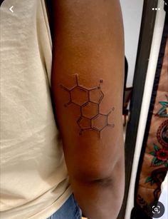 a woman with a tattoo on her arm that shows the structure of a honeycomb