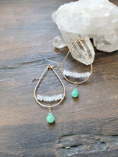 These teardrop hoops feature the beautiful semi precious stones of Chrysoprase (green) and Moonstone. This combination of gems is so pretty and beachy! Perfect for the Summertime! It adds a gorgeous touch of color to an outfit. The teardrop hoops are hand formed and lightly hammered for texture and shape. Moonstone gems are lined and wire wrapped across the bottom of the hoop while a pretty Chrysoprase gem dangles at the bottom. The length of the earrings are just a little longer than 2 1/4 in. Bohemian Teardrop Earrings With Gemstone Accents, Bohemian Green Earrings With Gemstone Accents, Bohemian Gemstone Teardrop Earrings, Green Teardrop Earrings With Gemstone Accents, Teardrop Chrysoprase Gemstone Jewelry, Bohemian Teardrop Jewelry With Gemstone Accents, Green Teardrop Gemstone Jewelry, Green Teardrop Jewelry With Gemstone Accents, Green Teardrop Gemstone Accents Jewelry