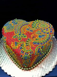 a decorative heart shaped cake sitting on top of a plate