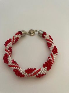 a red and white beaded bracelet with silver clasp