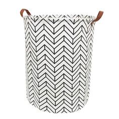 a black and white laundry basket with leather handles on the handle, featuring an arrow pattern