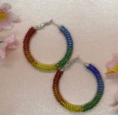 These bead wrapped hoop earrings are made with stainless steel hoops that are also hypoallergenic.  Our quality beaded hoops go with anything and are easy to wear.  Available in three sizes (30mm, 40mm, 50mm) Rainbow Beads, Beaded Wraps, Beaded Hoops, Etsy Earrings, Hoop Earrings, Beaded Bracelets, Beads