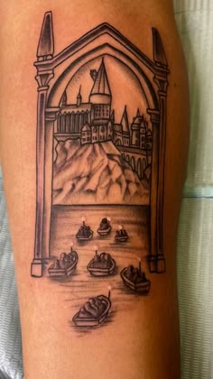 a black and white tattoo with an image of a castle