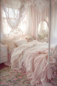 a white bed sitting under a window next to a pink comforter on top of a bed