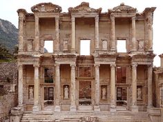 an old building with many windows and steps leading up to the top floor, in ruins