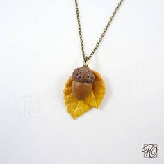 "Acorn Pendant Necklace - has been handcrafed using high-quality polymer clay. Acorn is a symbol of  Good Luck and Strength, and will be a great gift for nature lovers. Acorn w/golden tone bail  Pendant approximately 1-3/4\" long and 1-1/4\" wide. Comes with 18 \" (45cm) antiqued brass metal chain with a lobster claw clasp. ♦ Materials: polymer clay, antiqued brass metal chain. ♦ Care Card included with purchase.  ♦ This is not a toy and not designed for small children. ♦ Comes in a jewelry box. Perfect to give as a present to someone special or to yourself! This one of a kind pendant necklace is AVAILABLE for purchase and READY TO SHIP immediately.  * I do my very best to take pictures and describe my items as accurately as possible and show you the entire piece. Please note, that real co Clay Acorn, Polymer Clay Fall, Acorn Pendant, Acorn Necklace, Antique Brass Metal, Golden Leaves, Fall Jewelry, Care Card, Gifts For Nature Lovers